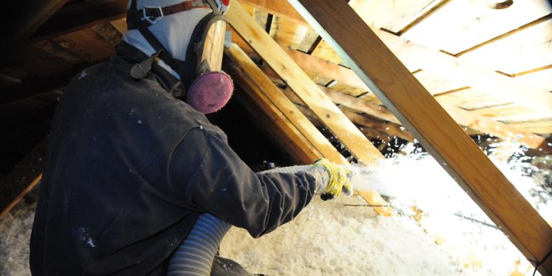 Eastside technician spraying foam into an attic
